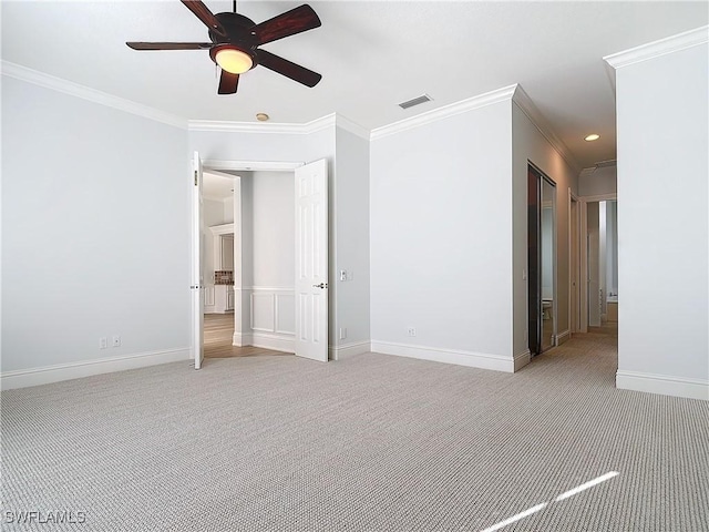 carpeted spare room featuring ornamental molding and ceiling fan