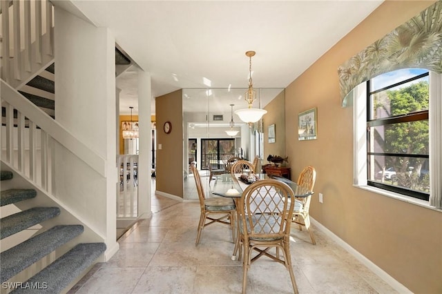 dining space with plenty of natural light and an inviting chandelier