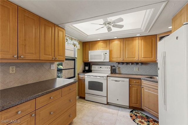 kitchen with ceiling fan, tasteful backsplash, white appliances, a tray ceiling, and ornamental molding