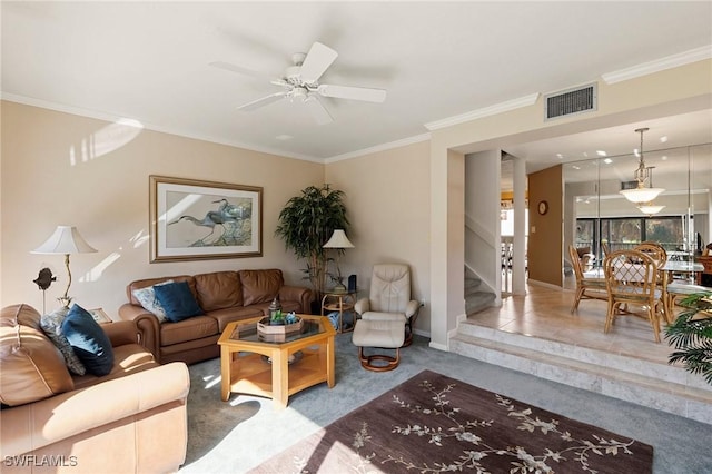 living room featuring carpet floors, ceiling fan, and crown molding