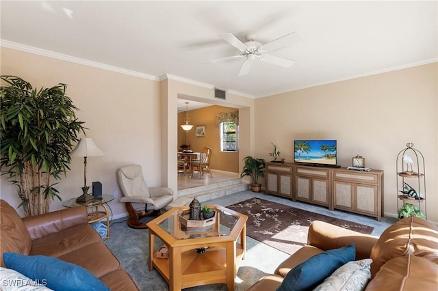 carpeted living room featuring ceiling fan and ornamental molding