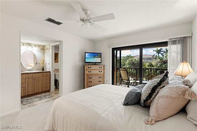 carpeted bedroom featuring access to outside, ensuite bathroom, sink, and ceiling fan