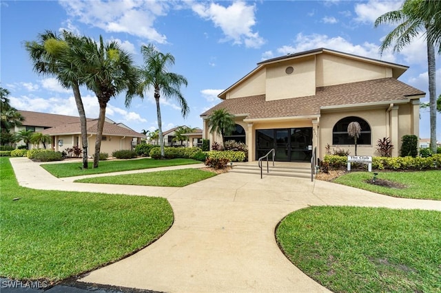 view of property's community with a yard