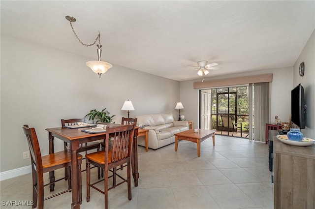 tiled dining space with ceiling fan