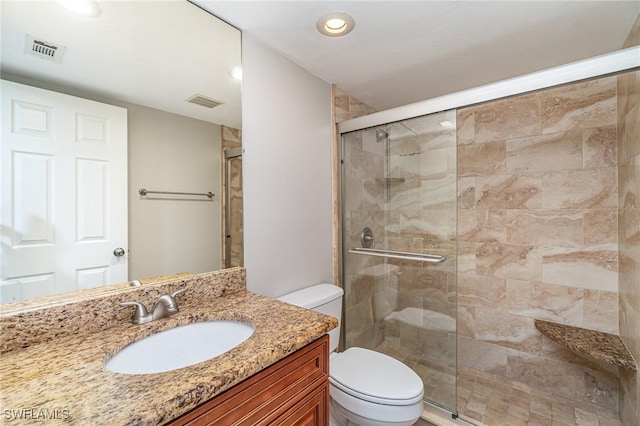 bathroom featuring walk in shower, vanity, and toilet