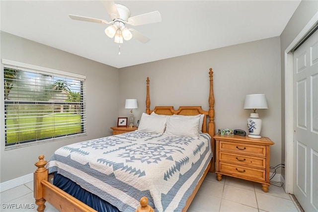 tiled bedroom featuring a closet and ceiling fan