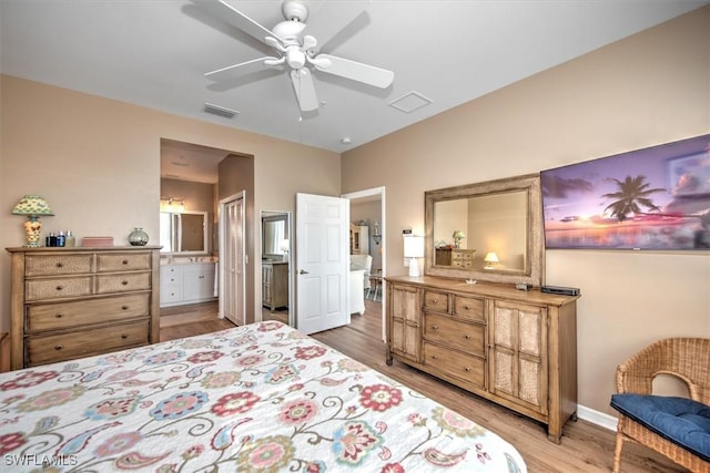 bedroom featuring connected bathroom, ceiling fan, and light hardwood / wood-style flooring