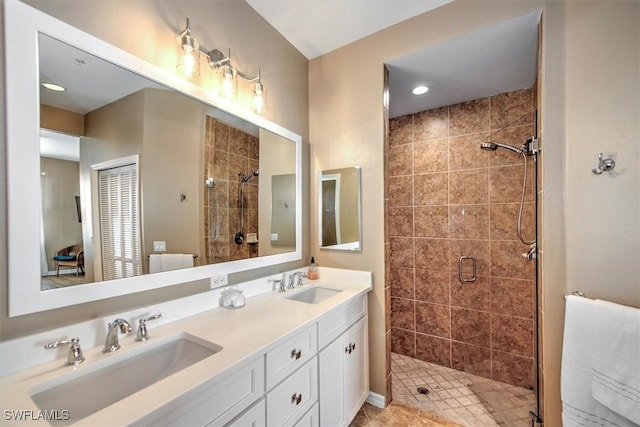 bathroom featuring vanity and an enclosed shower