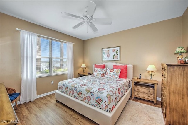 bedroom featuring light wood-type flooring and ceiling fan