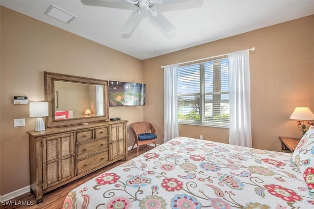 bedroom with ceiling fan and wood-type flooring