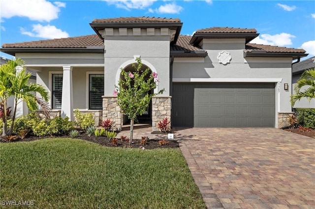 mediterranean / spanish house with a front yard and a garage