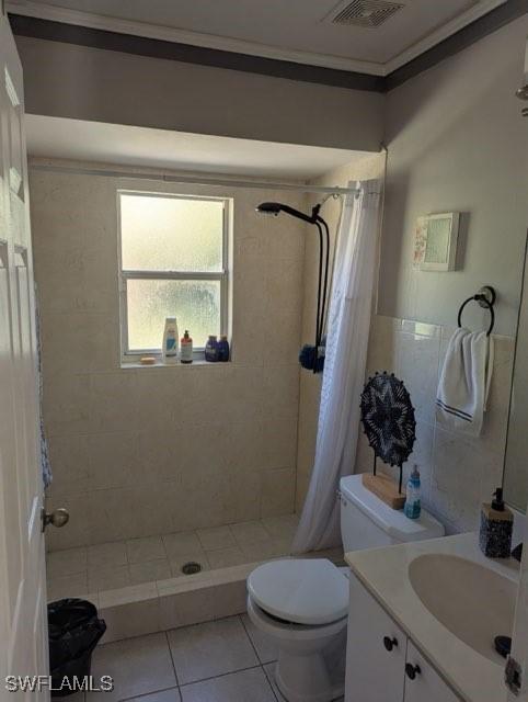 bathroom with tile patterned flooring, vanity, toilet, and a shower with shower curtain