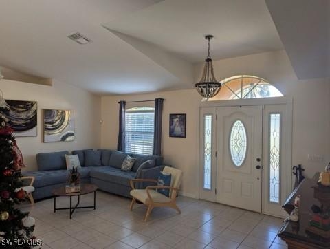 entrance foyer featuring light tile patterned floors and a chandelier