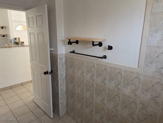 bathroom with tile patterned flooring and walk in shower