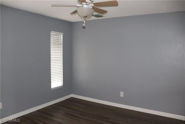 spare room with dark hardwood / wood-style floors and ceiling fan