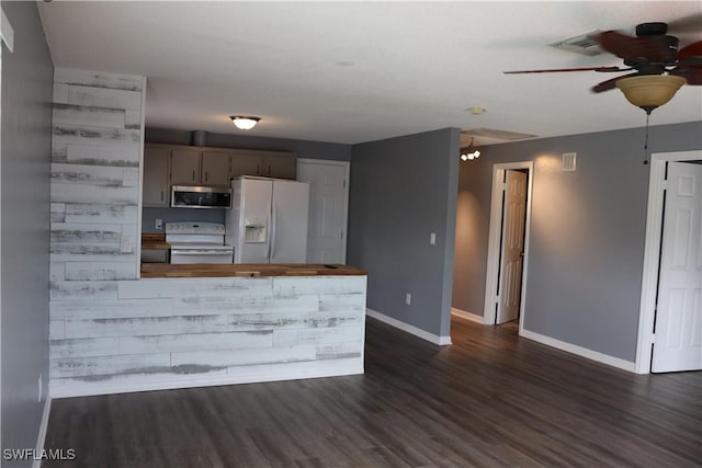 kitchen featuring ceiling fan with notable chandelier, dark hardwood / wood-style flooring, and white appliances