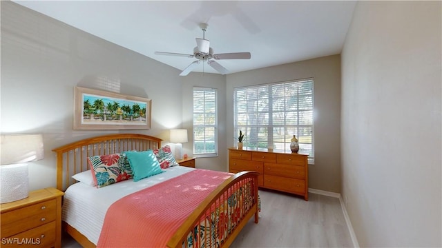 bedroom with ceiling fan and light hardwood / wood-style flooring