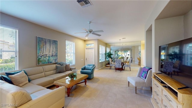 living room with a wealth of natural light and ceiling fan