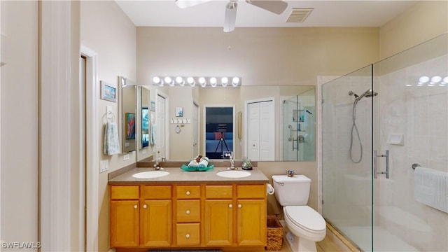 bathroom with vanity, toilet, walk in shower, and ceiling fan