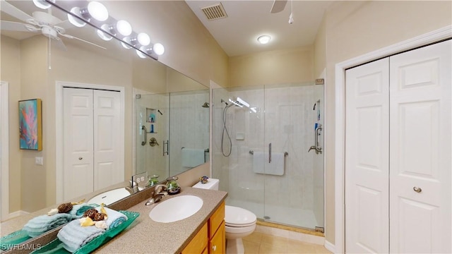 bathroom featuring ceiling fan, toilet, vanity, and walk in shower