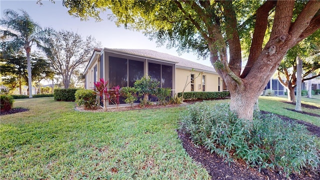 view of front of property featuring a sunroom and a front lawn