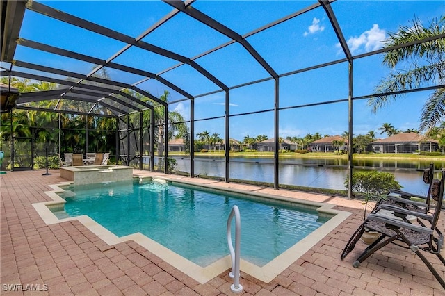 view of pool with an in ground hot tub, a water view, glass enclosure, and a patio