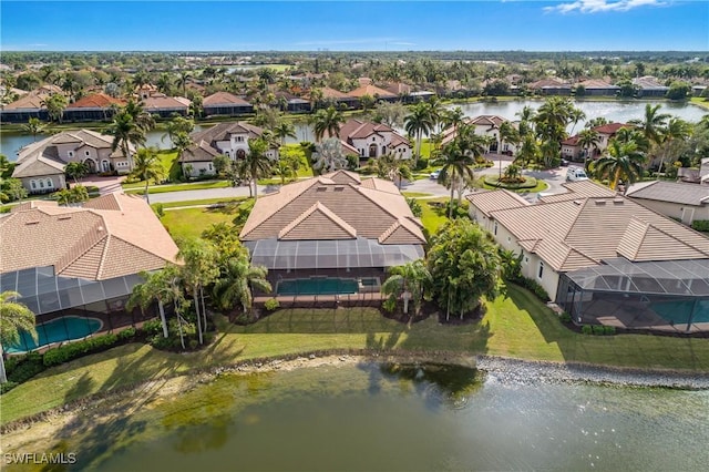 drone / aerial view featuring a water view and a residential view