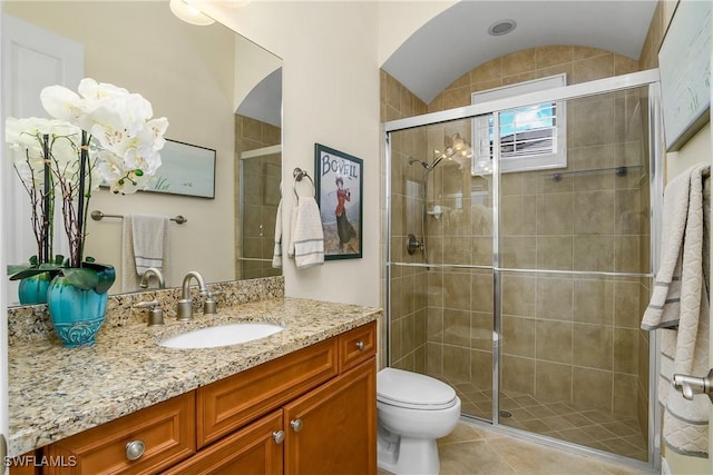 bathroom with walk in shower, tile patterned floors, vanity, and toilet