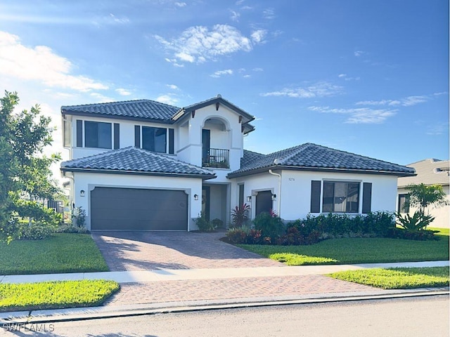 view of front of house with a balcony, a garage, and a front lawn