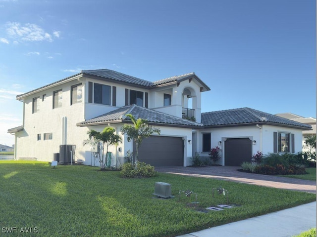 mediterranean / spanish-style home featuring central AC unit, a balcony, and a front yard