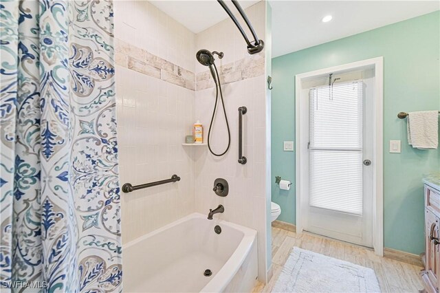 full bathroom with vanity, toilet, wood-type flooring, and shower / tub combo