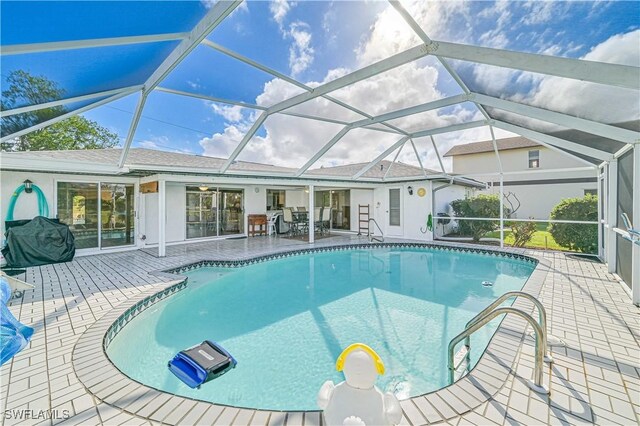 view of pool with a patio and a lanai