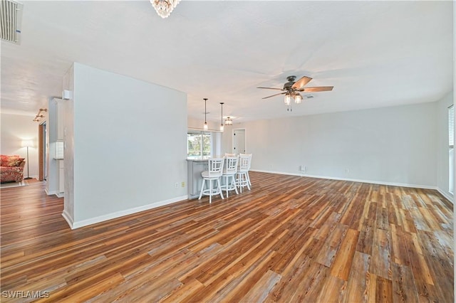 unfurnished living room with hardwood / wood-style floors and ceiling fan