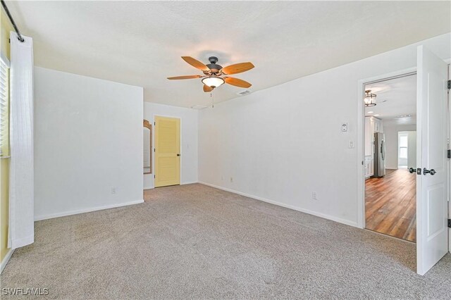 spare room with light wood-type flooring and ceiling fan