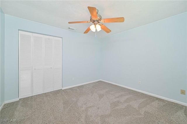 unfurnished bedroom with ceiling fan, carpet floors, and a closet