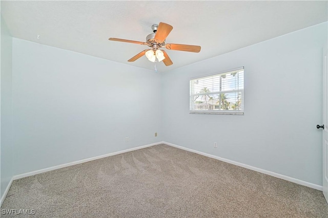 unfurnished room featuring ceiling fan and carpet