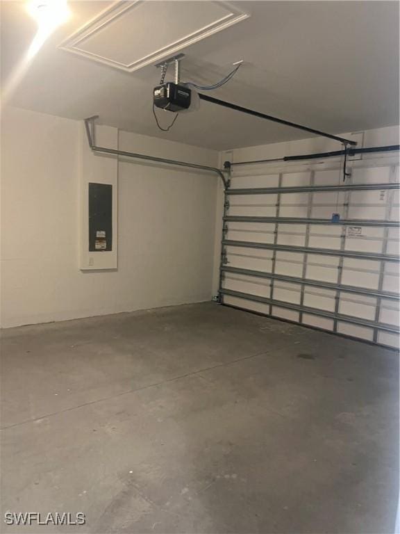 garage featuring electric panel and a garage door opener