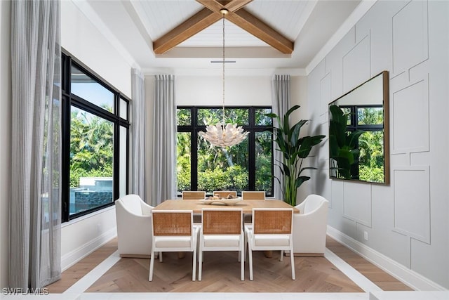 dining room with a notable chandelier, plenty of natural light, and beam ceiling