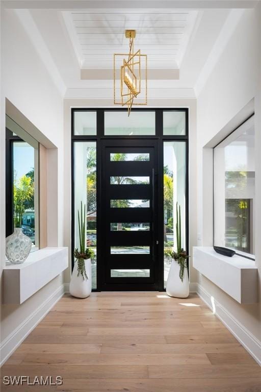 doorway featuring wood-type flooring and a chandelier