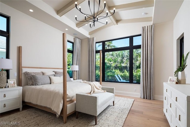 bedroom with vaulted ceiling with beams, light hardwood / wood-style floors, and a chandelier