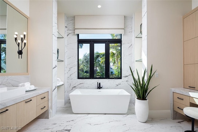 bathroom featuring vanity and a bath