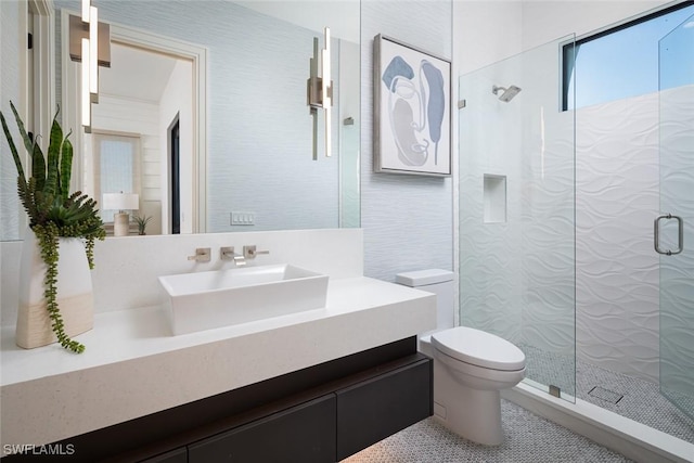 bathroom featuring tile patterned floors, vanity, toilet, and an enclosed shower