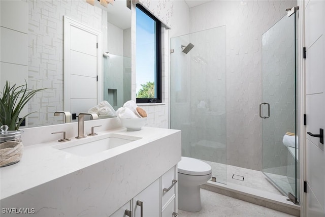 bathroom with vanity, a shower with shower door, and toilet