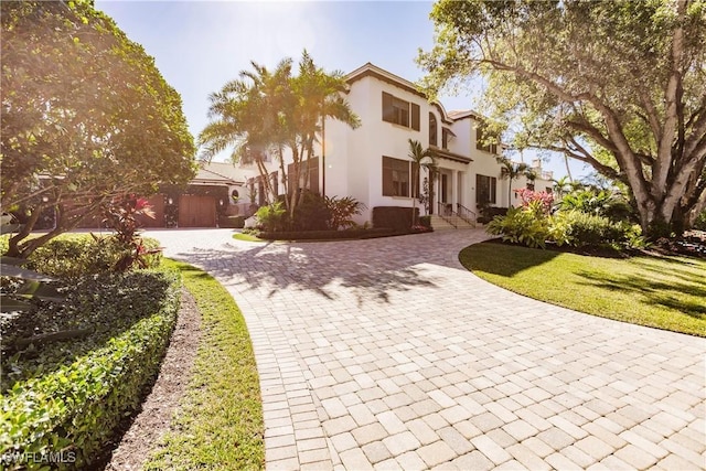 mediterranean / spanish-style house featuring a front lawn