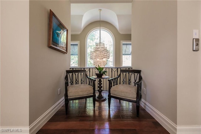 sitting room with wood-type flooring and an inviting chandelier