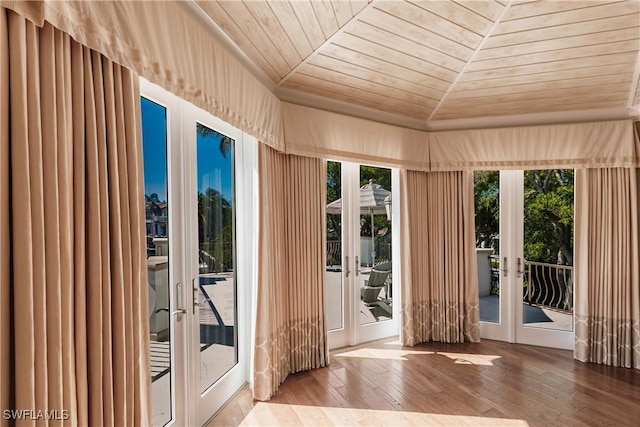 entryway featuring wood-type flooring, wood ceiling, and french doors