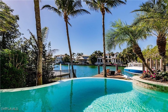 view of swimming pool featuring a water view