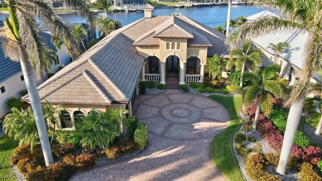 view of front of home with a porch and a water view