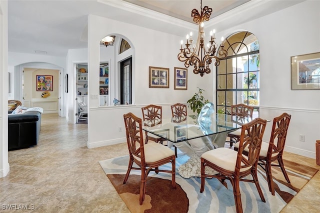 tiled dining area featuring a notable chandelier and crown molding