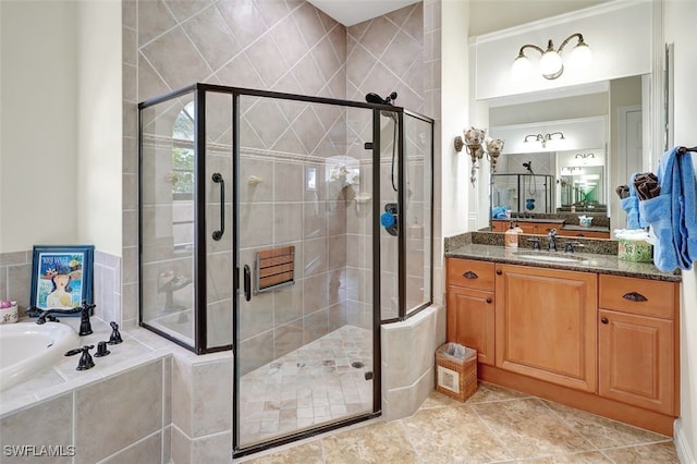 bathroom featuring tile patterned flooring, vanity, and plus walk in shower